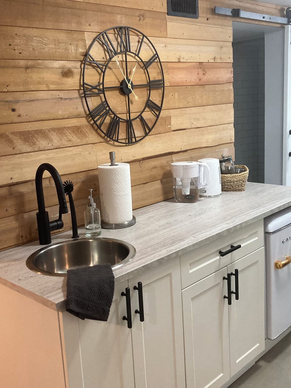 Kitchenette with microwave and mini fridge. BBQ grill outdoors for guest use.