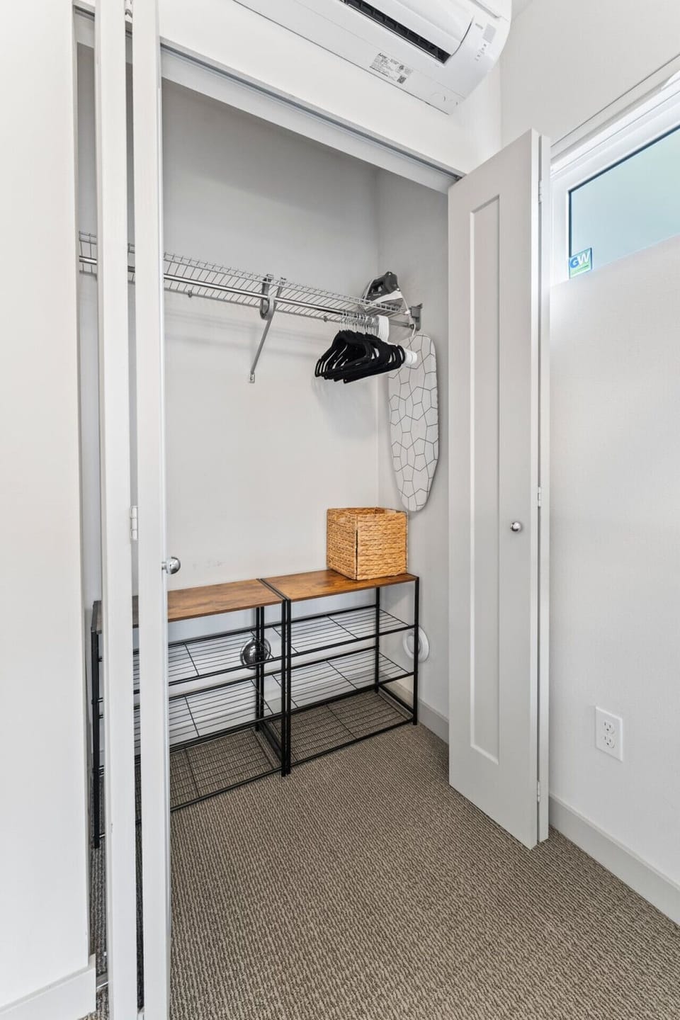 A walk-in closet with ample space for clothes, towels, and a dedicated hanging area.