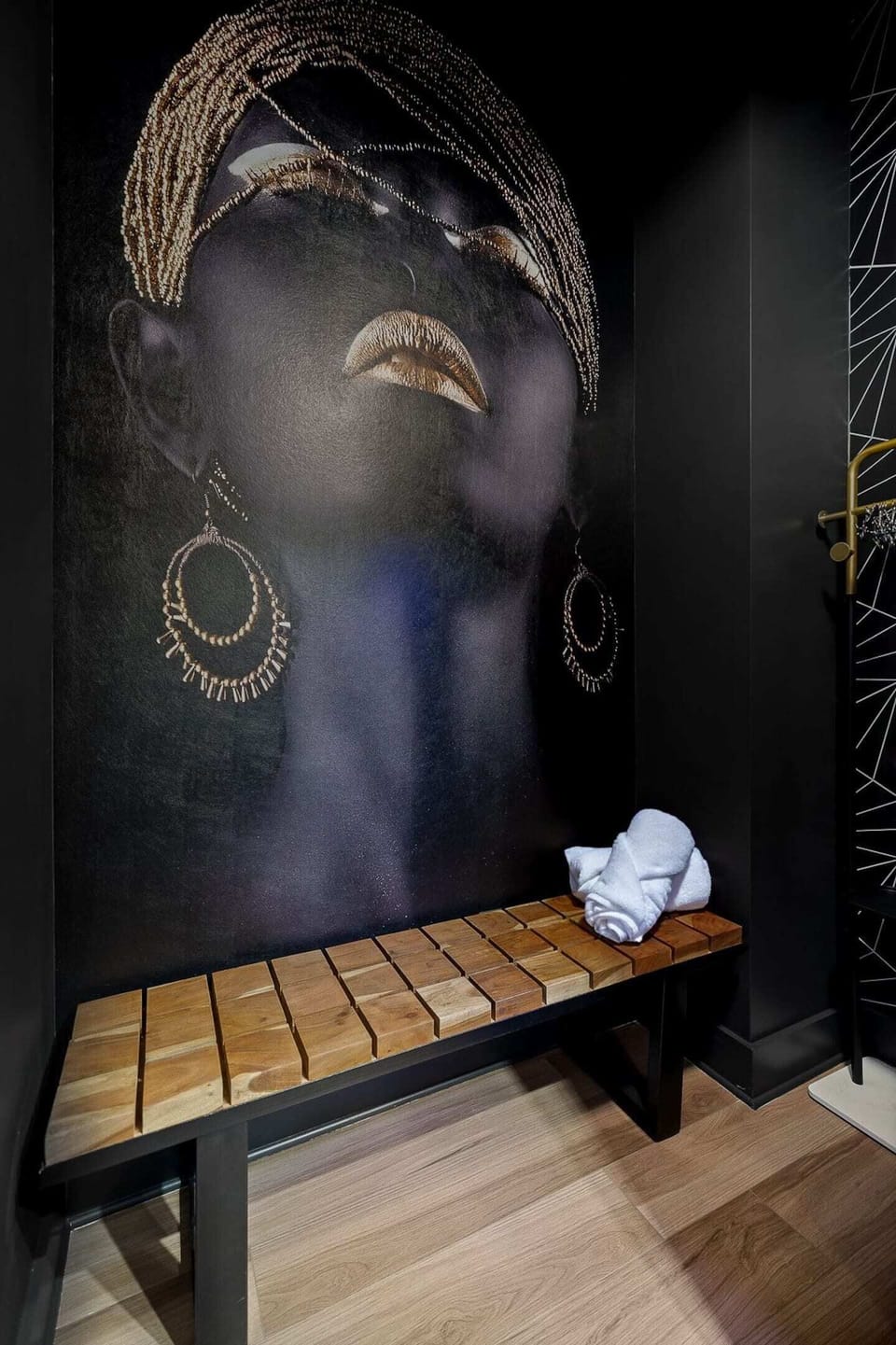 Townhouse 1: Sauna room seating area with extra towels. Room also has 2 clothing racks to hang clothes and a luggage rack for your suitcase