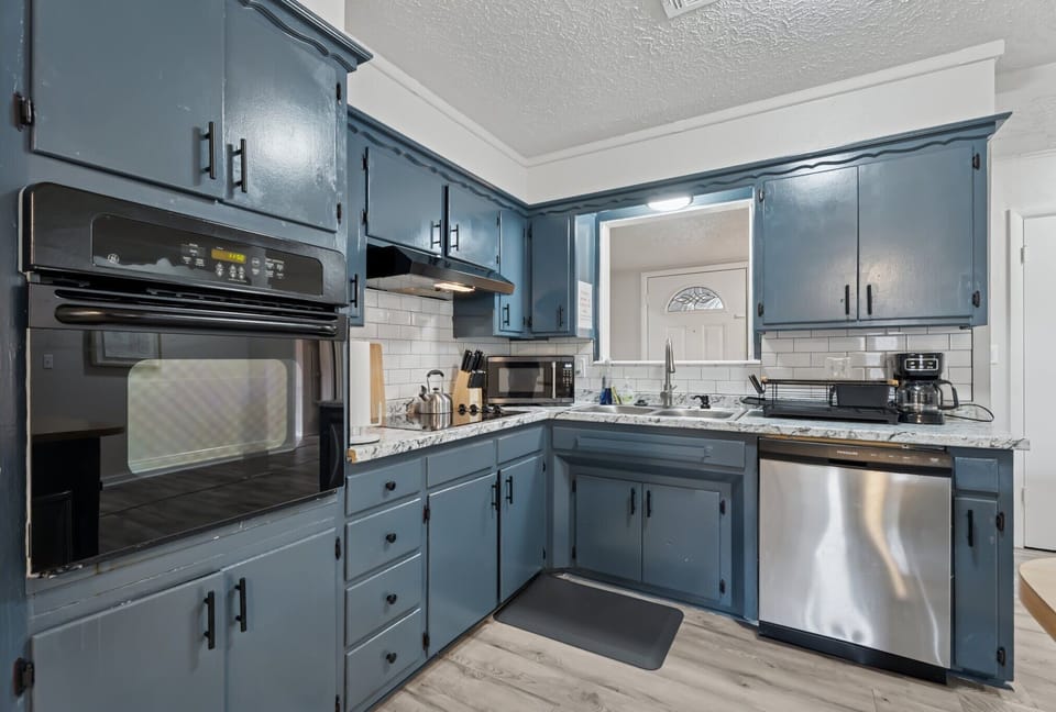 Cook like a pro in this stylish kitchen featuring a double oven, sleek stovetop, granite counters, and all the essentials—just bring your ingredients.