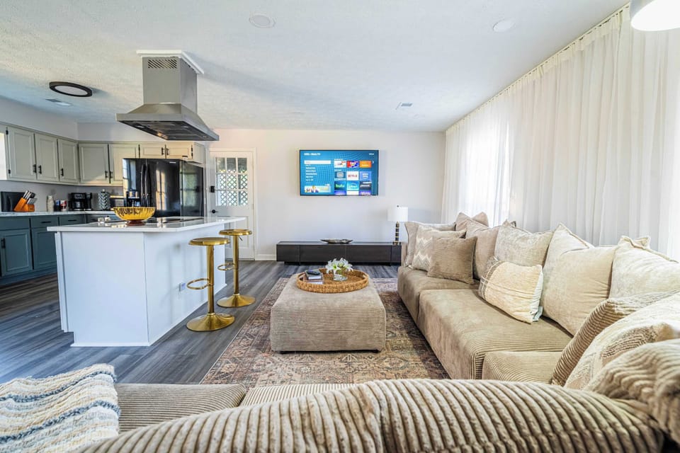 "Spacious living area with a plush sectional sofa."


