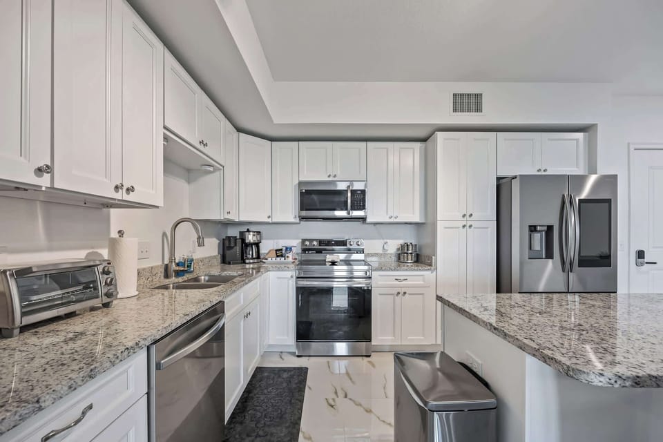 Modern kitchen with stainless steel appliances and granite countertops