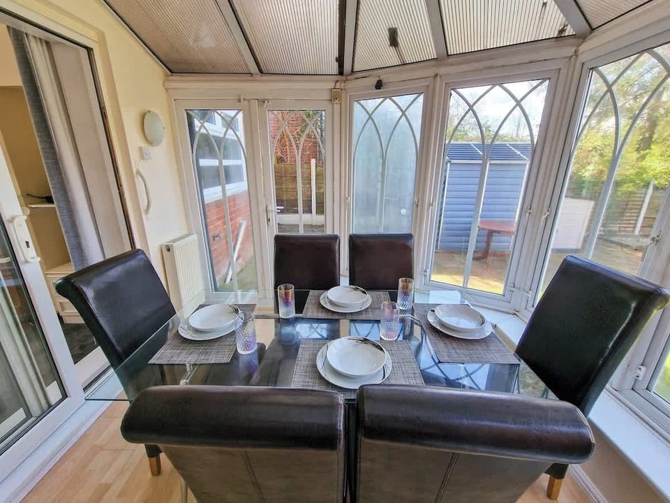 Dine in style in the conservatory with seating for the whole family and beautiful garden views