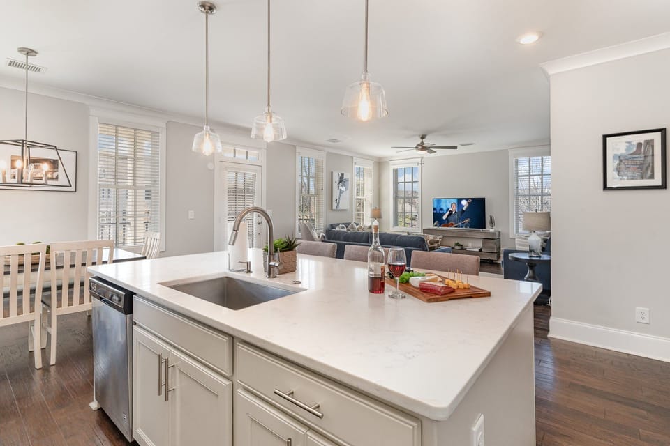 Fully equipped kitchen stocked with all culinary essentials, stainless steel appliances and an island offering bar seating for 3 guests.