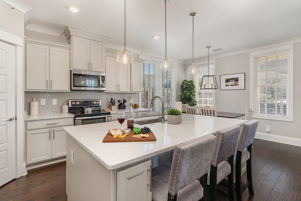 Fully equipped kitchen stocked with all culinary essentials, stainless steel appliances and an island offering bar seating for 3 guests.