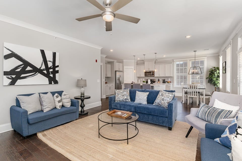 An open and inviting living space featuring a Smart TV and cozy furnishings, including 1 Queen sleeper sofa and 2 Twin sleeper sofas. Access to private balcony.