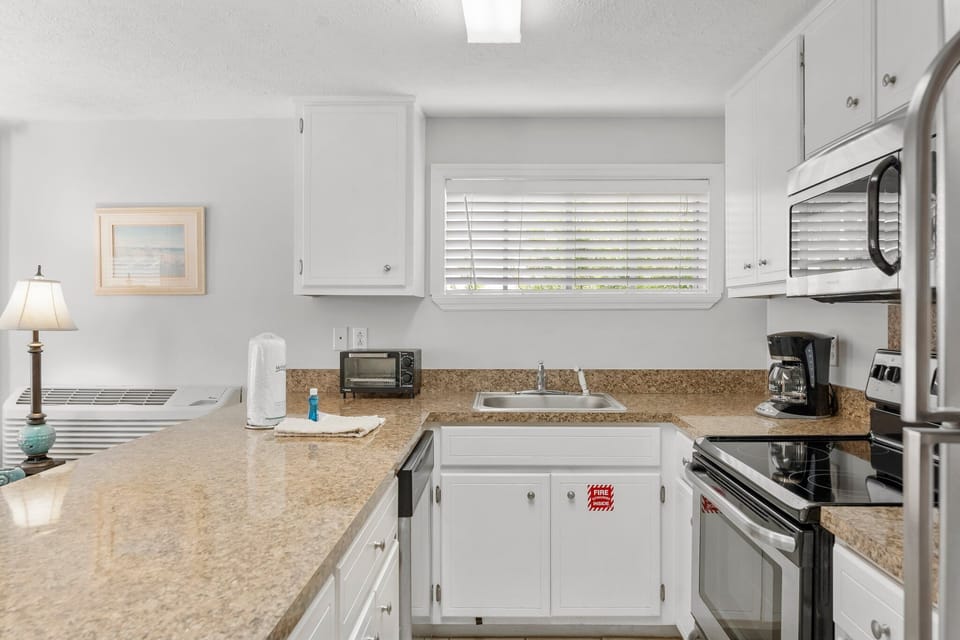 modern kitchen with granite countertops and stainless steel appliances