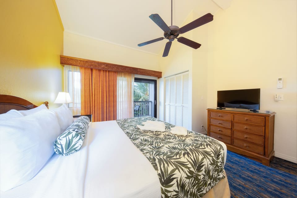 Unwind in bed with easy closet storage and TV.