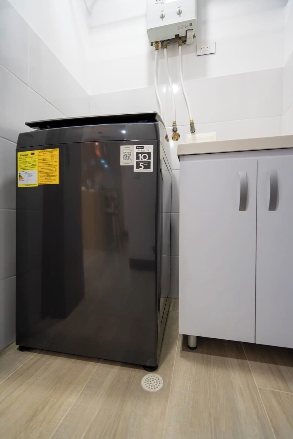 Washer located inside apartment by the kitchen. 