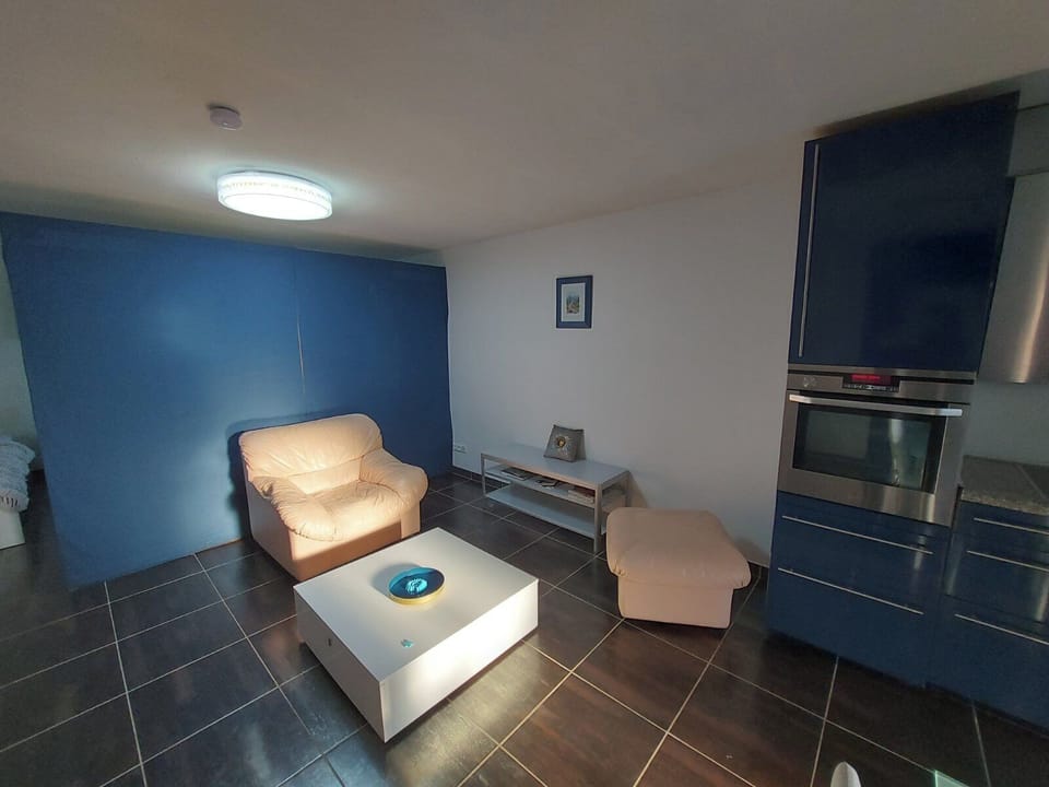 Sitting room with leather couch, new TV which can be switched to your PC/laptop