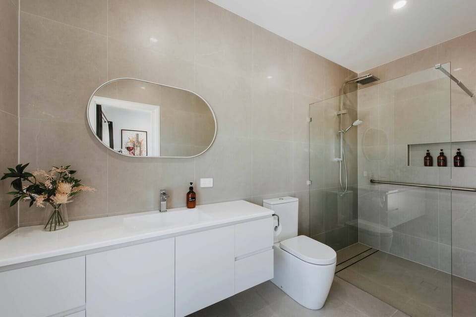 Freshen up in the spacious ensuite with a large vanity, walk-in shower, and complimentary toiletries. 
