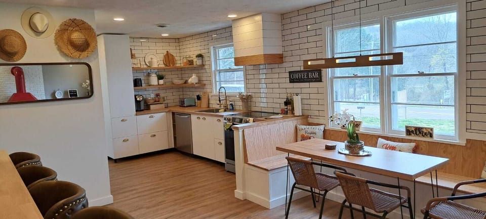 Stylish kitchen and dining space with large windows and views of wine country