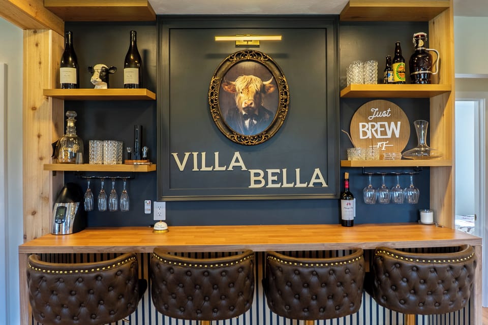Signature Villa Bella bar with custom woodwork, wine display, and cozy seating