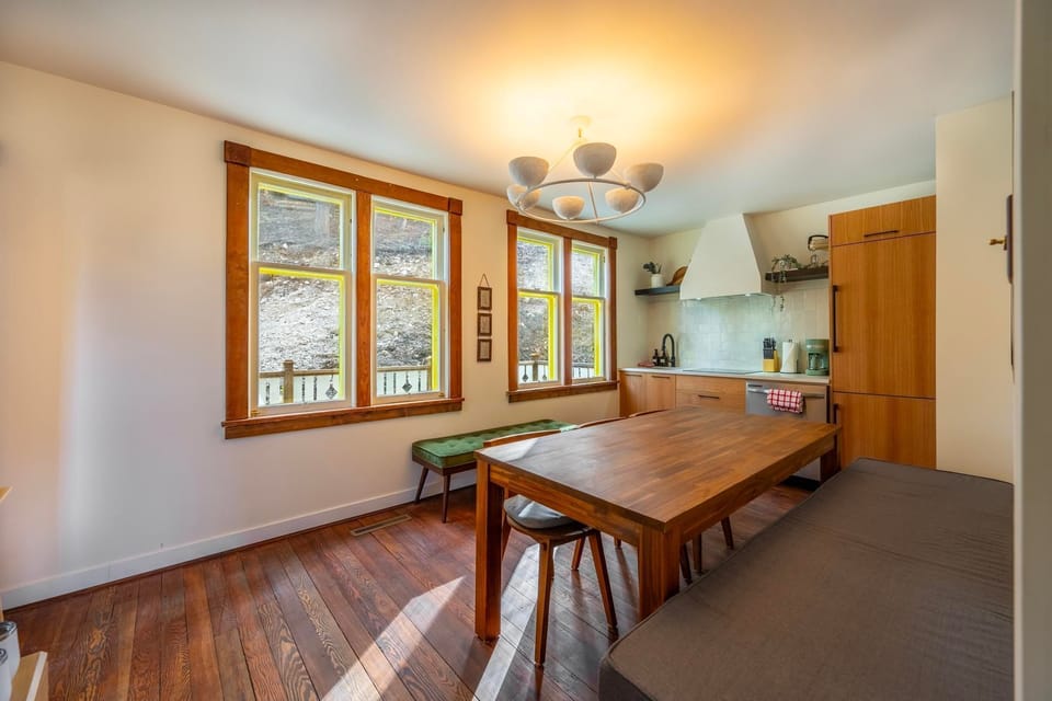 Contemporary kitchen meets rustic charm, featuring modern amenities and inviting seating.