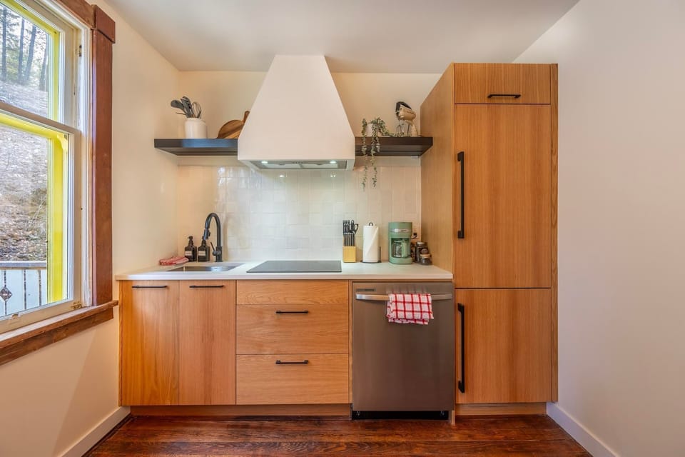 Light floods this modern kitchen, equipped for your culinary adventures with stylish finishes.
