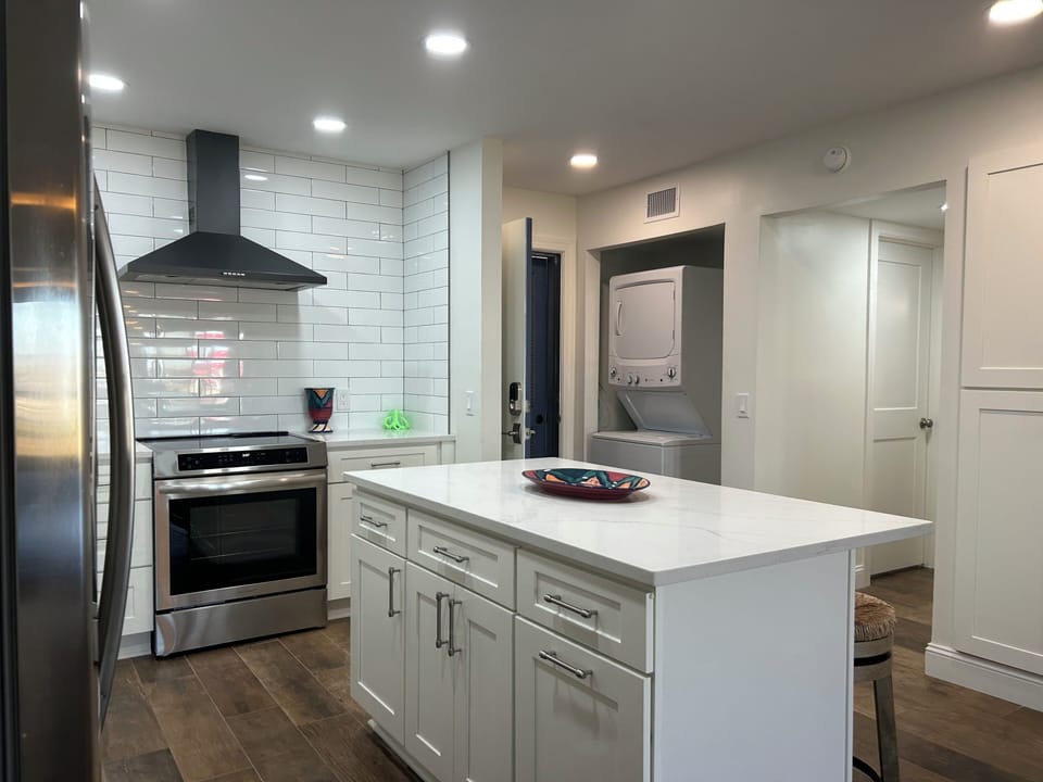 Kitchen showing laundry space.