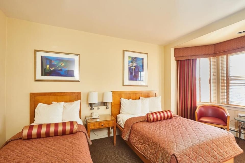 Drift off comfortably with two beds and soft, warm lighting.