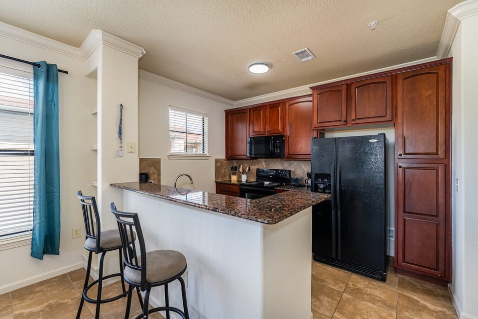 Kitchen showing breakfast bar with seating for 2
