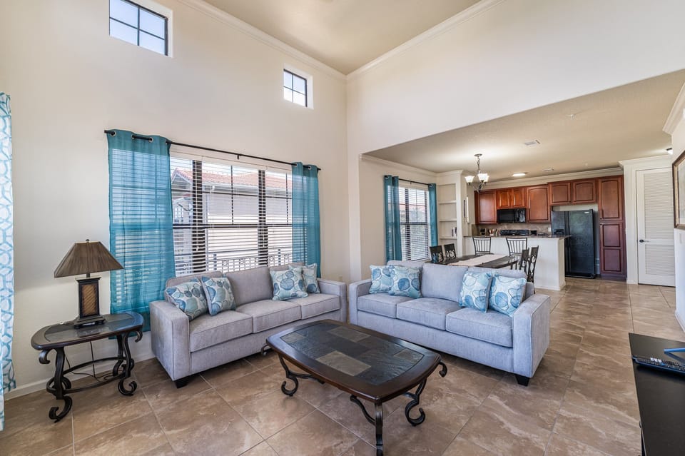 Living room showing seating, dining room and kitchen.