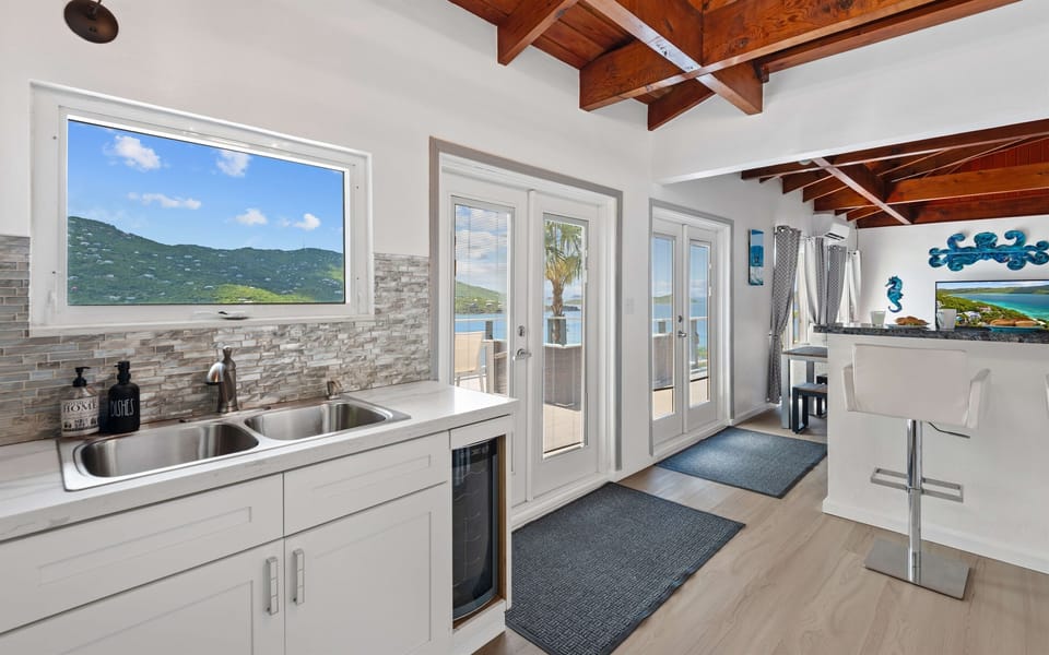 When you enter off of the wrap around balcony, you step into the kitchen and living room space.