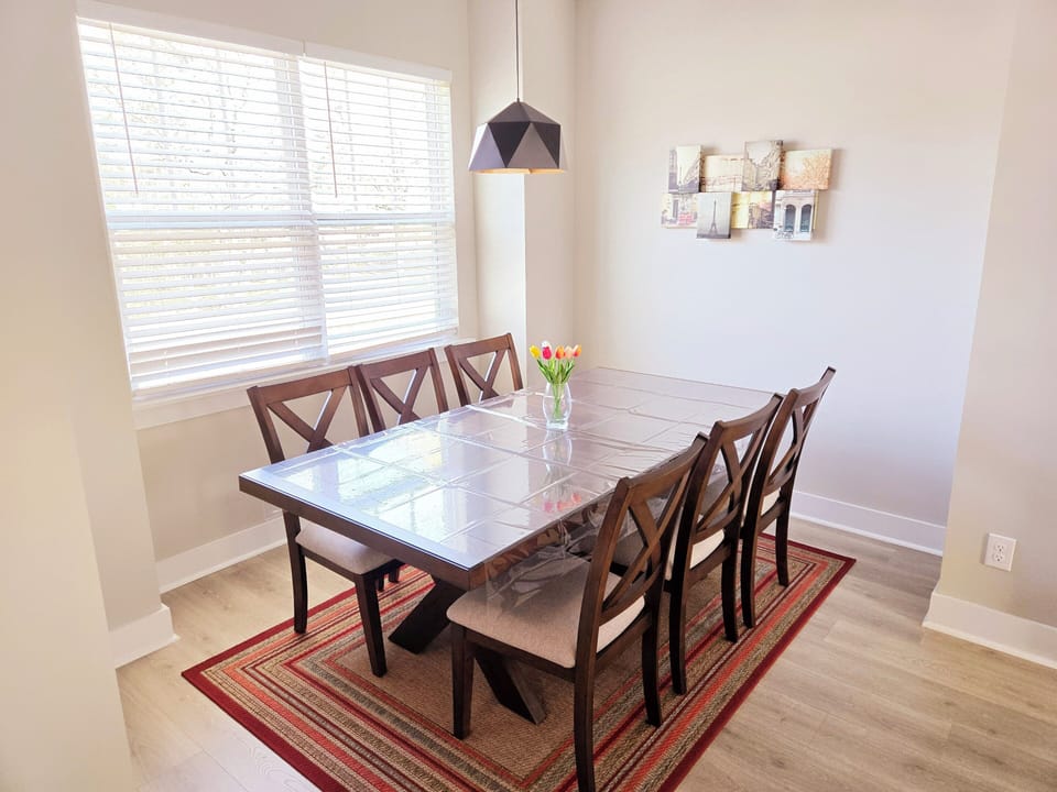 The spacious layout seamlessly connects the 6-seater dining area with kitchen.