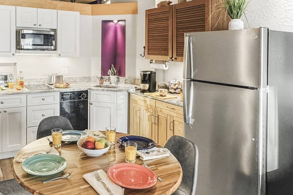 Enjoy a meal in the comfort of our spacious, open-concept condo—perfect for relaxing and dining in style. Side A.