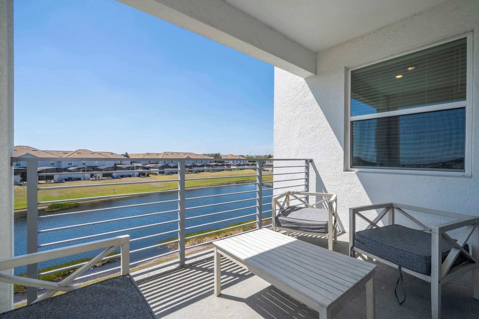 Balcony view overlooking canal and homes: Not just a balcony – it’s your front row seat to peace. Waterfront views that slap every time.