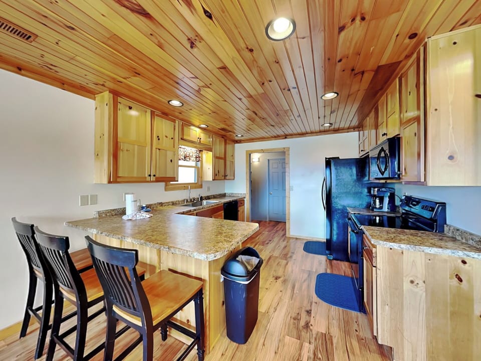 Fully Equipped Kitchen and Breakfast Bar Seating for Three