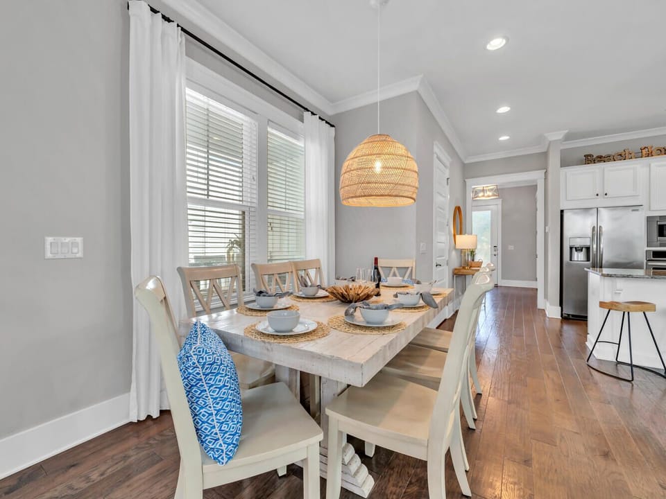 Gather around your dining table where coastal charm meets modern comfort, perfect for sharing meals with loved ones.