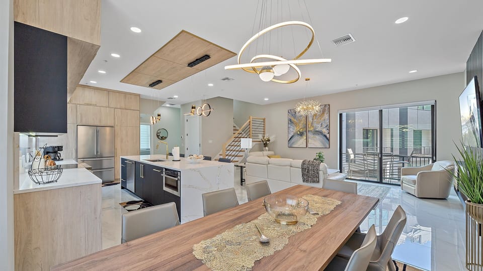 Host family and friends at the elegant dining table, perfectly situated between the gourmet kitchen and cozy living room.