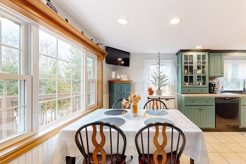 Cozy dining area with large windows, perfect for meals or morning coffee.