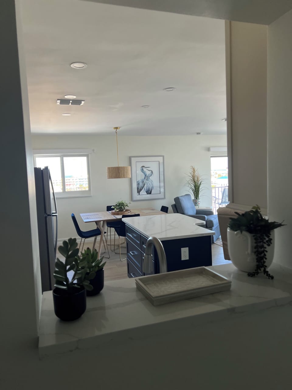 Entrance is light and airy with this cut out wall in kitchen.