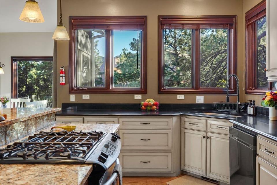Large fully stocked kitchen with Gas range stove, two ovens and center island.