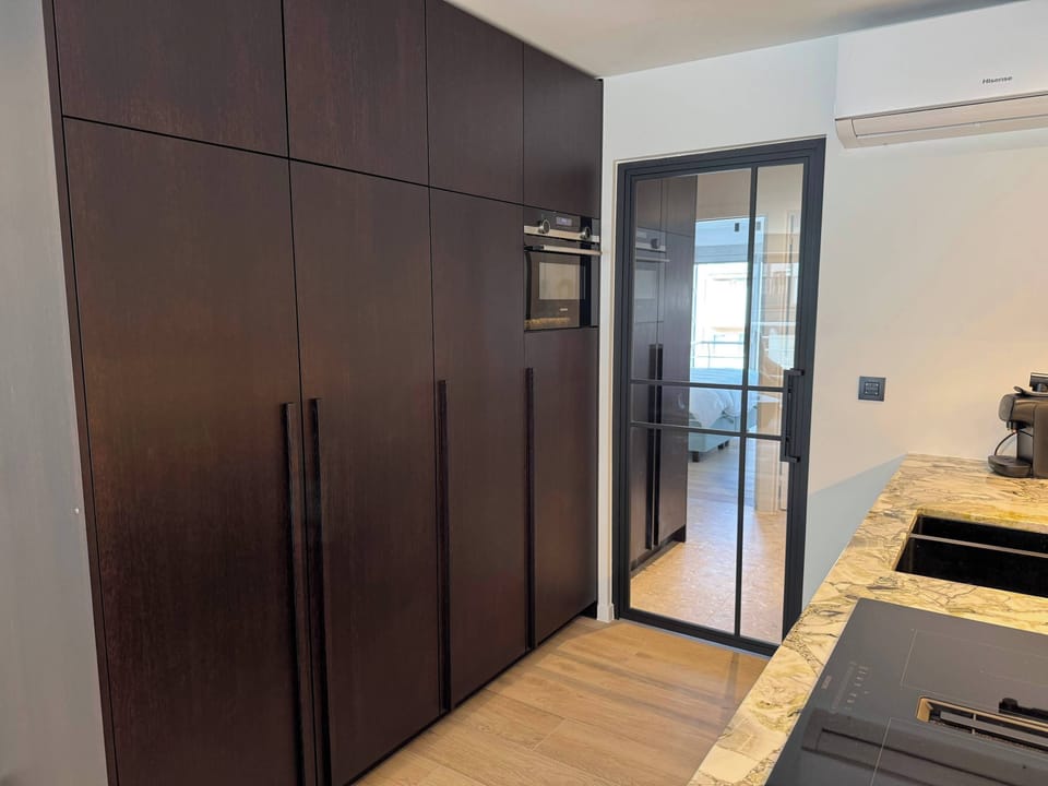 Contemporary kitchen with clean lines and dark wood accents.