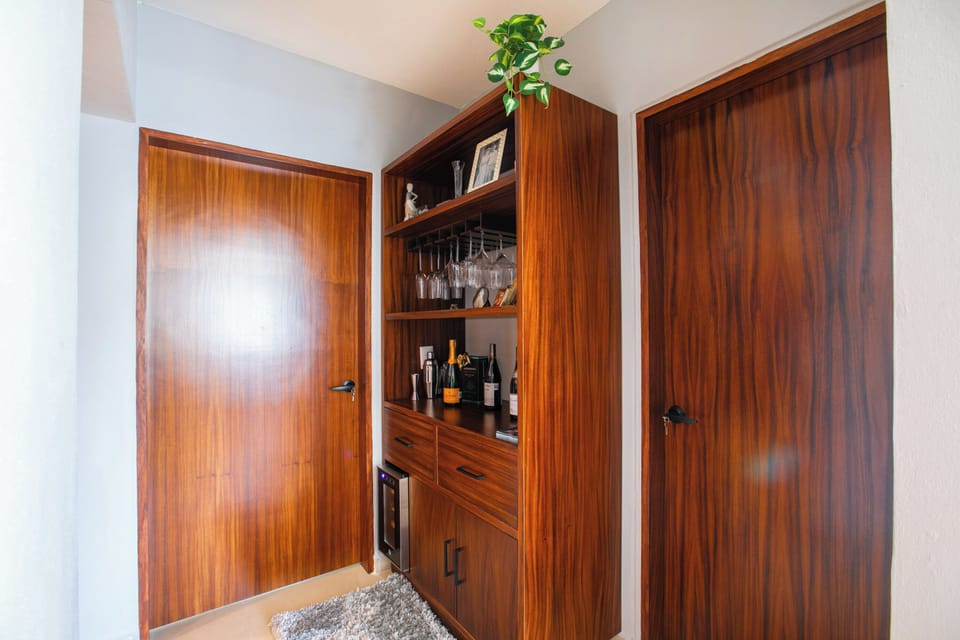 Bar station with glassware and a wine fridge, perfect for preparing your favorite drinks