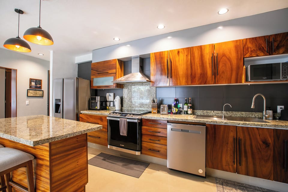 The sleek kitchen is fully equipped with top-of-the-line appliances