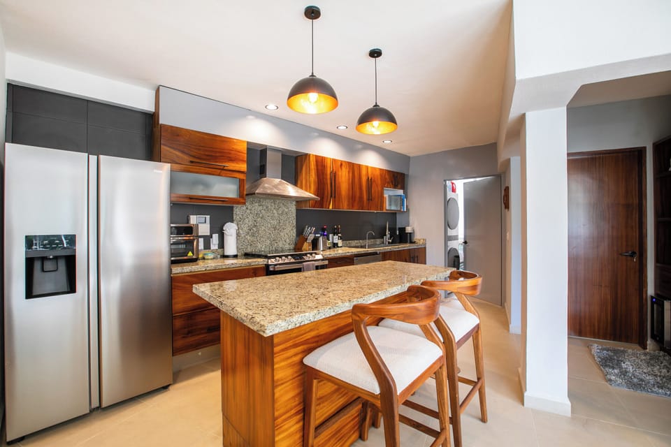 The fully equipped kitchen is complete with firdge, stove, oven and dishwasher