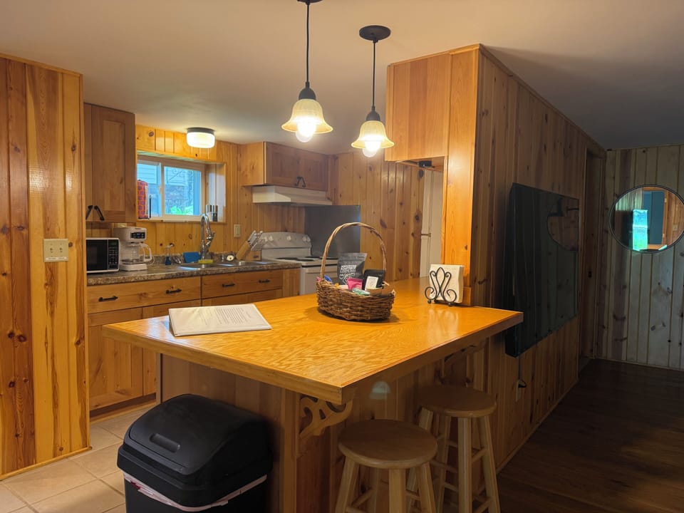 Large sit at counter with stools for additional seating.