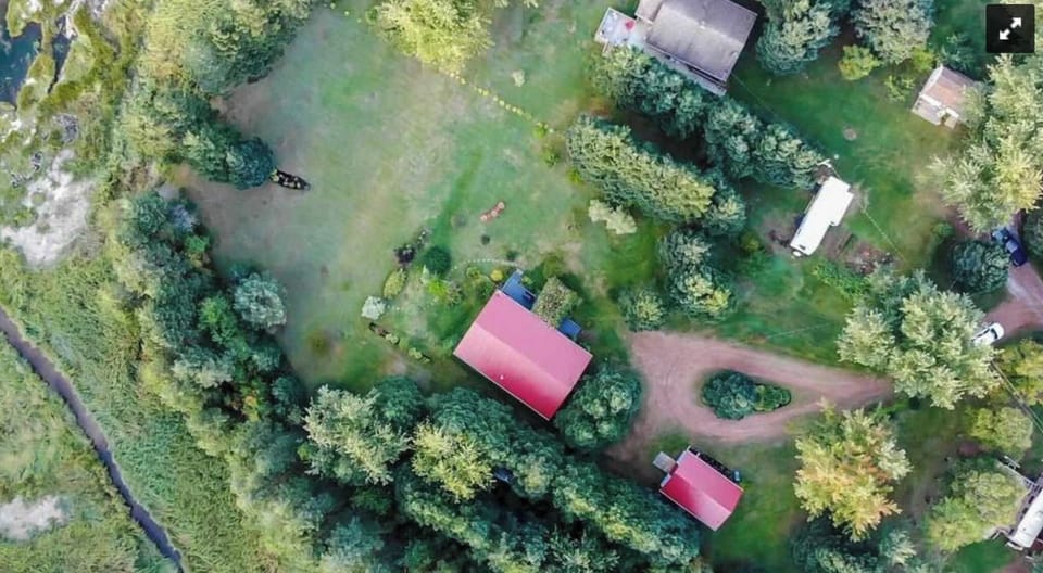 The two red roofed buildings are the main house and guesthouse. There are less t