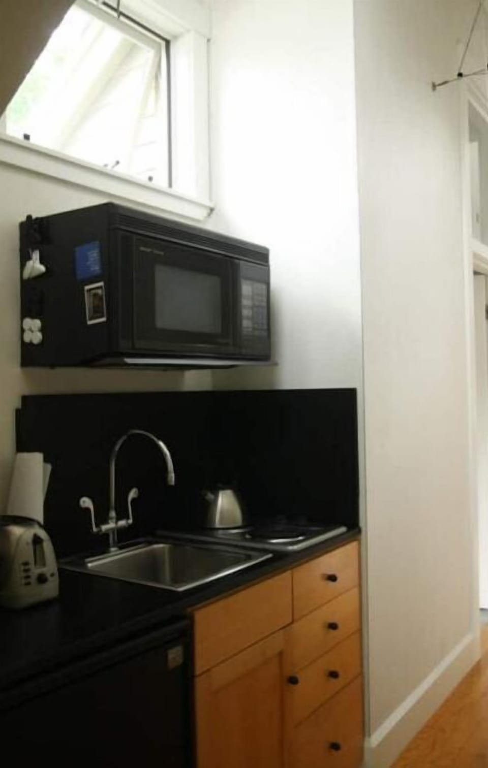 The kitchen has a microwave-convection oven, 2 burners, sink, & minifridge