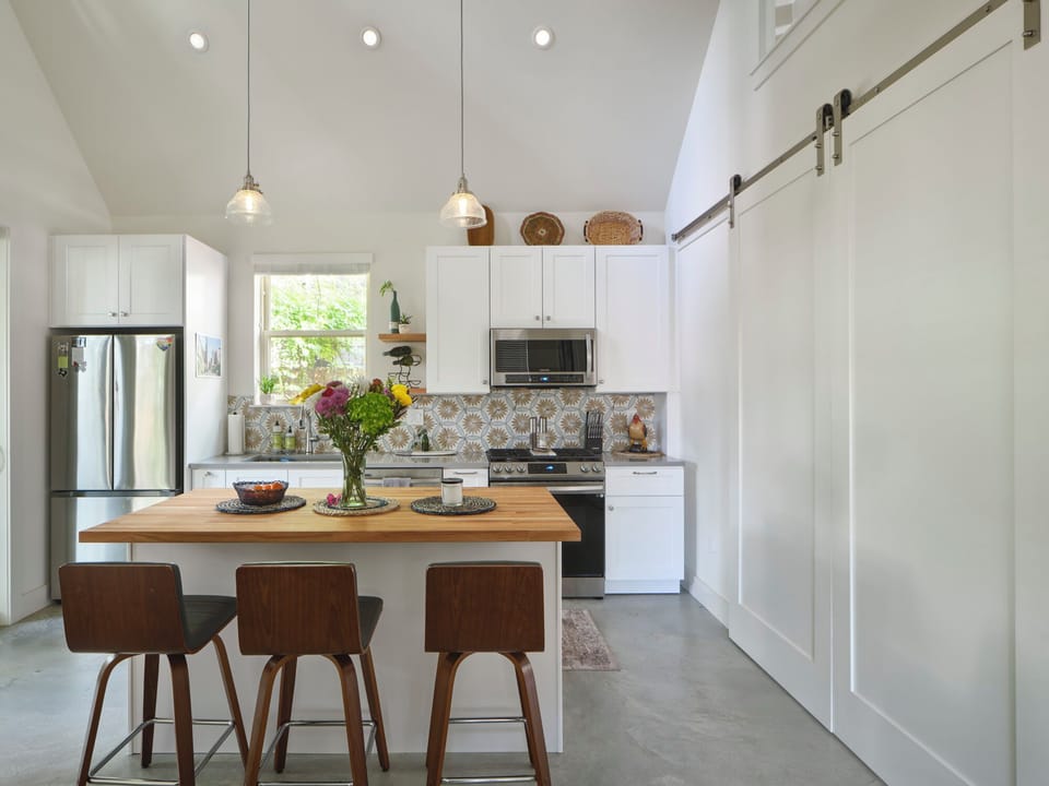 Kitchen seating area. Barn doors to bedroom closed.