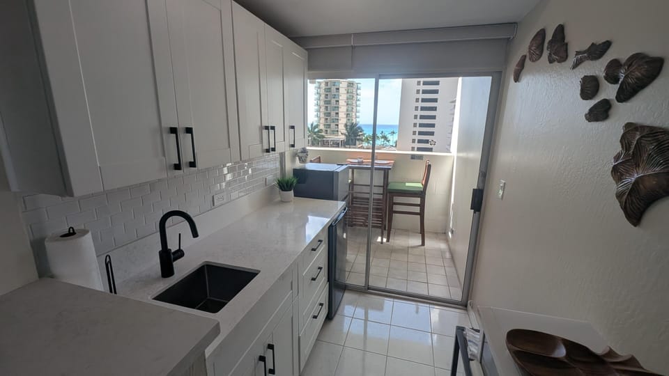 Bright, modern kitchen with cozy dining nook and city views