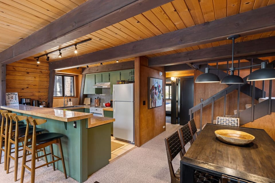 Fully loaded kitchen has kitchen bar stools and large dining table for 8.