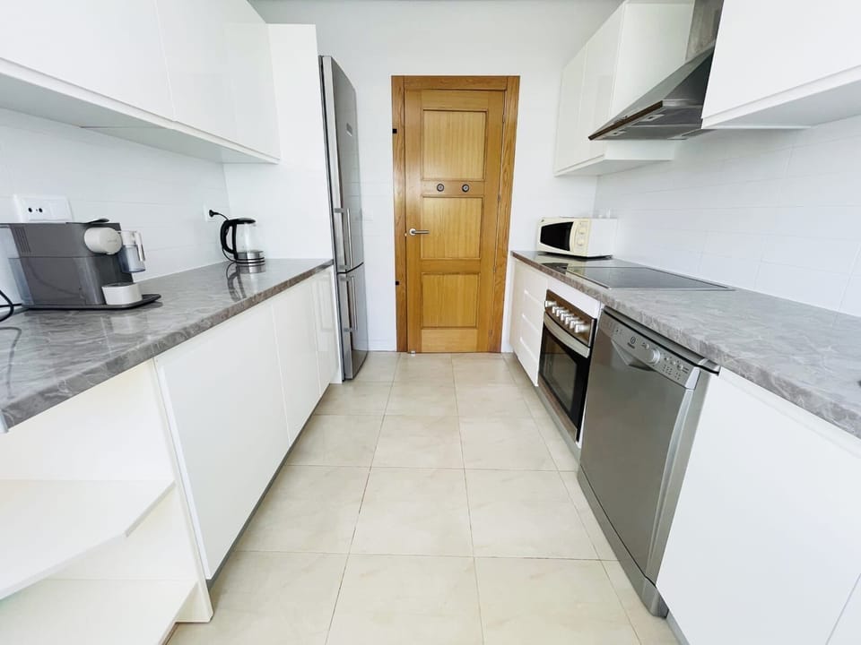 Fully equipped kitchen with dishwasher and access to the patio, BBQ and pool.