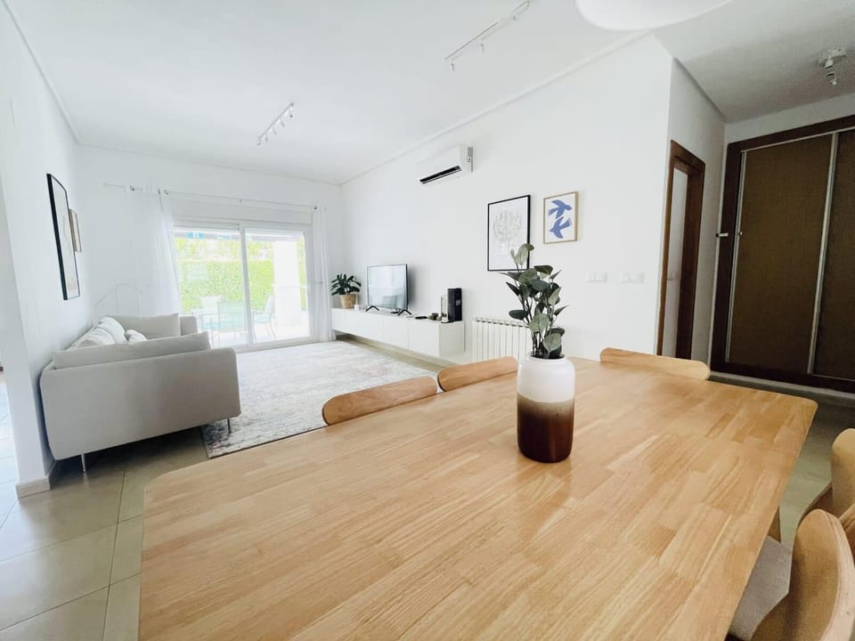 Bright and spacious indoor dining area with a large table that seats six people comfortably