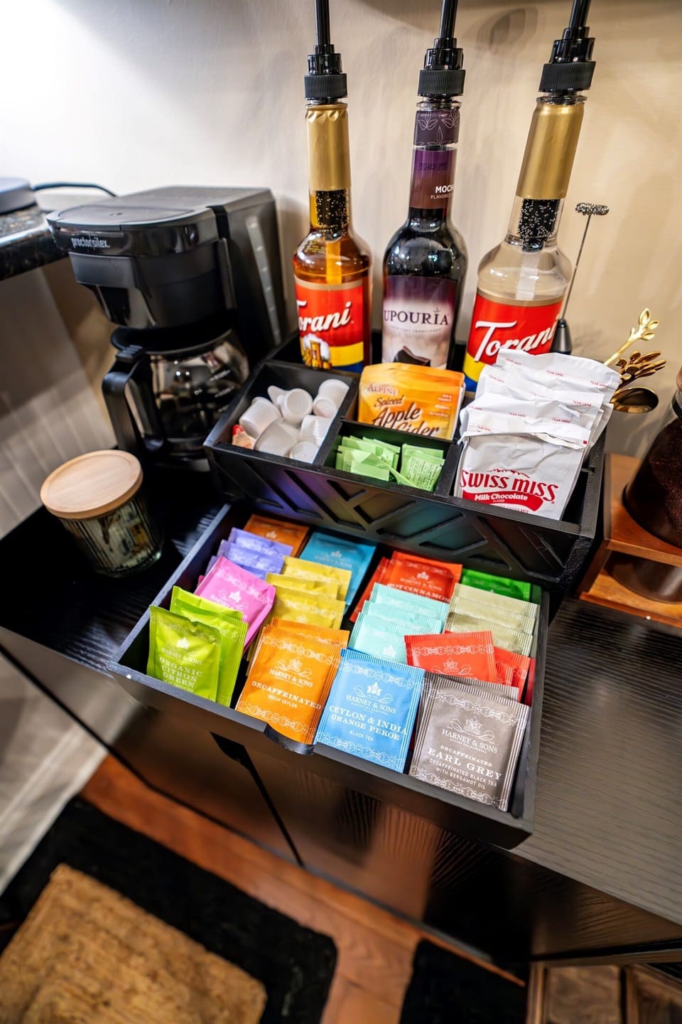 Stylish, well-stocked coffee bar with K-pod, Nespresso, drip, and French press — plus full selection of teas, artisan syrups, and sweet sips for every guest