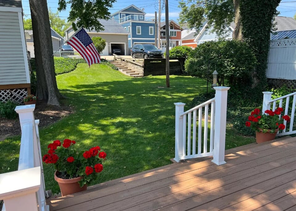 Back of House (nice grassy yard with a deck, patio furniture and 3-car parking area)