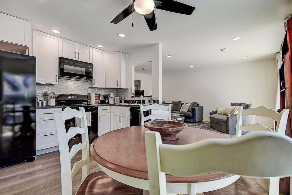 Gather, cook, and unwind in this open-concept space!  A fully equipped kitchen flows into a cozy dining and living area, perfect for sharing meals and memories #OpenConceptLiving
