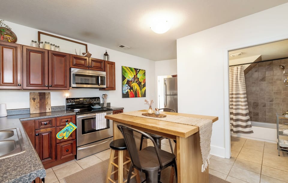 The spacious kitchen features rich wood cabinets and ample storage.