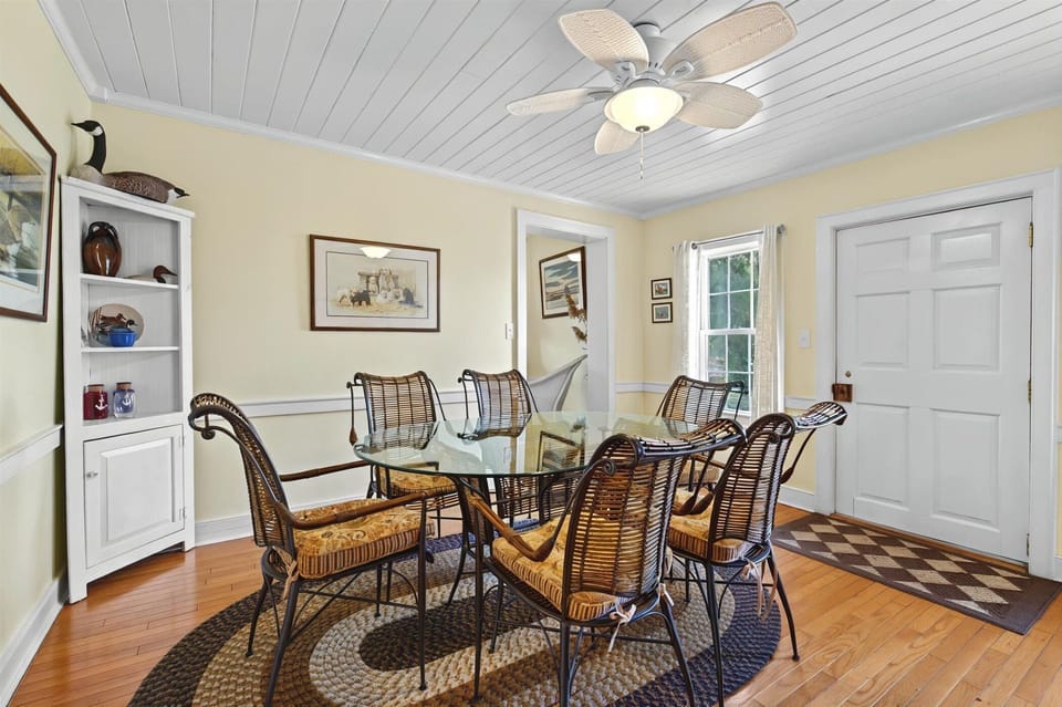 Another angle of the dining area showcasing easy access to both the kitchen and the front door.